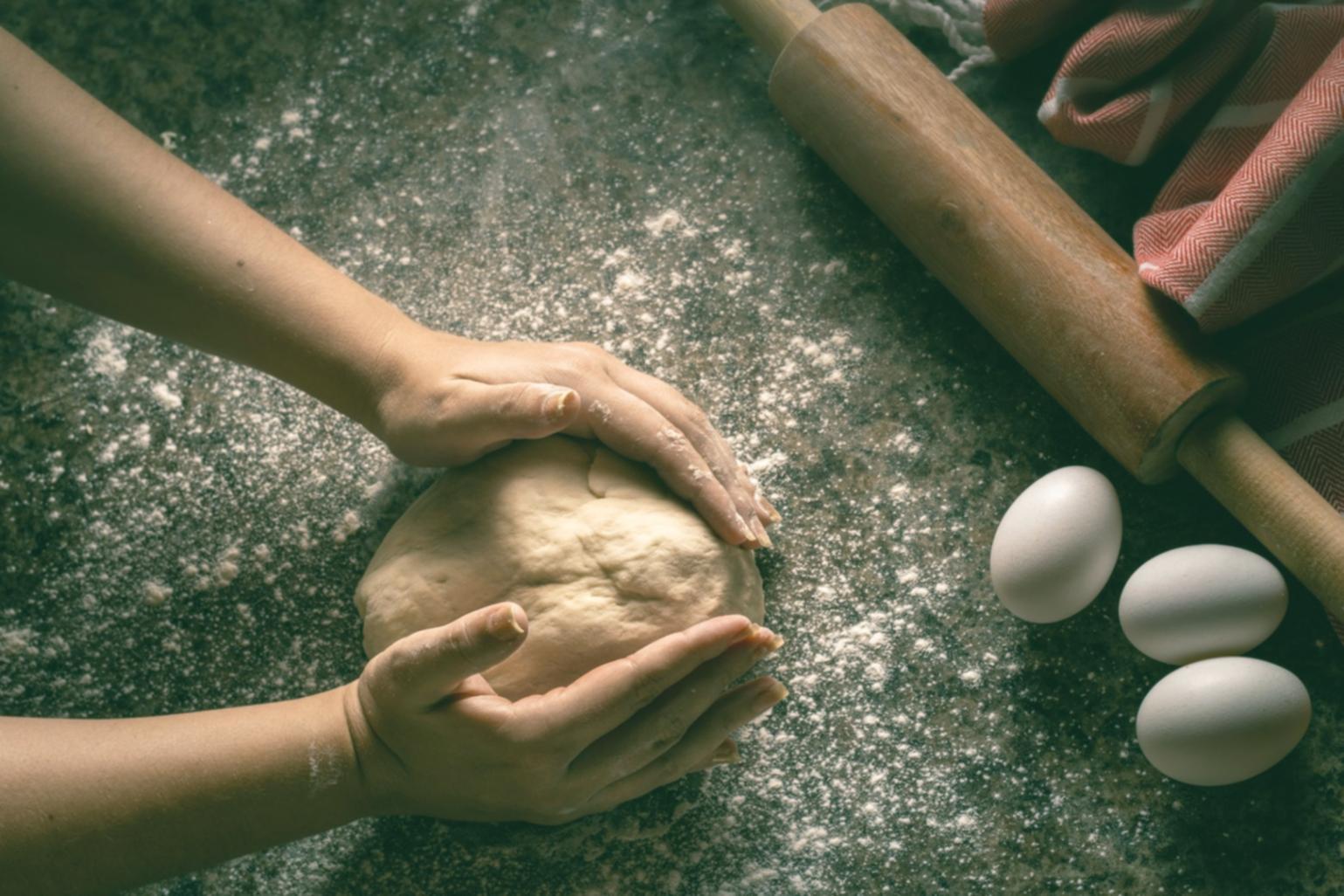 Student cooking in a home kitchen during an online lesson